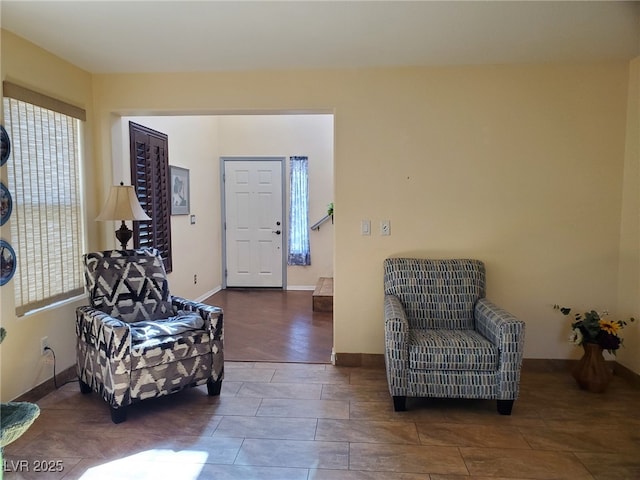 living area featuring baseboards