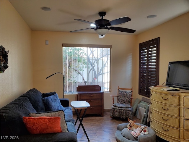 living area with ceiling fan