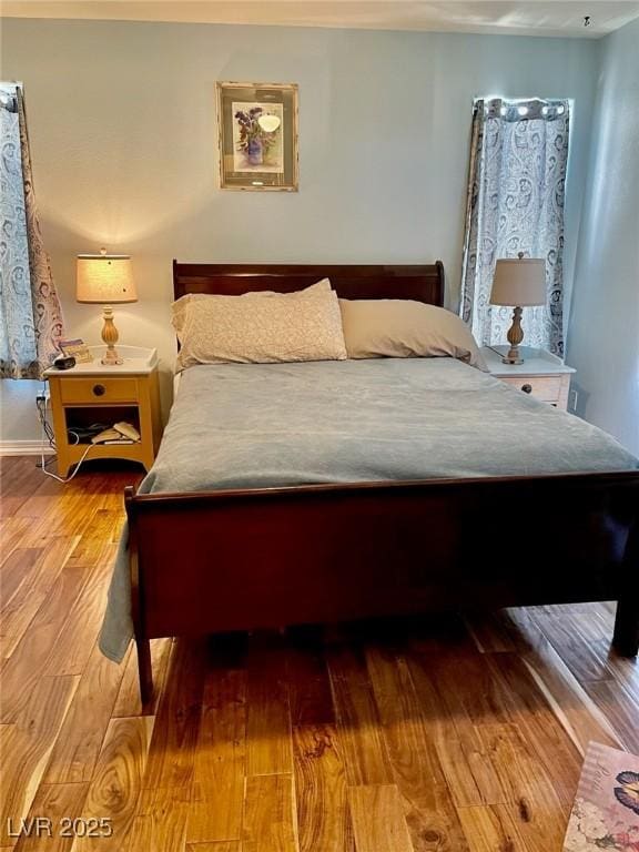 bedroom featuring baseboards and wood finished floors