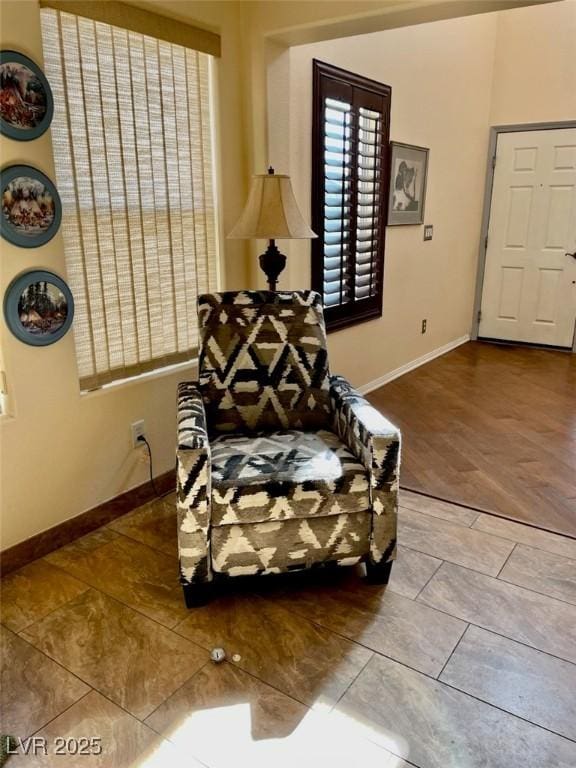 sitting room featuring baseboards and wood finished floors