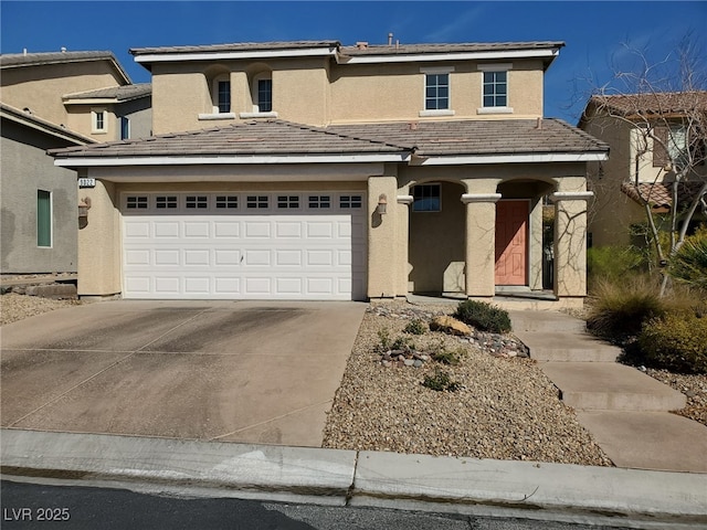 view of front of property with concrete driveway, an attached garage, and stucco siding