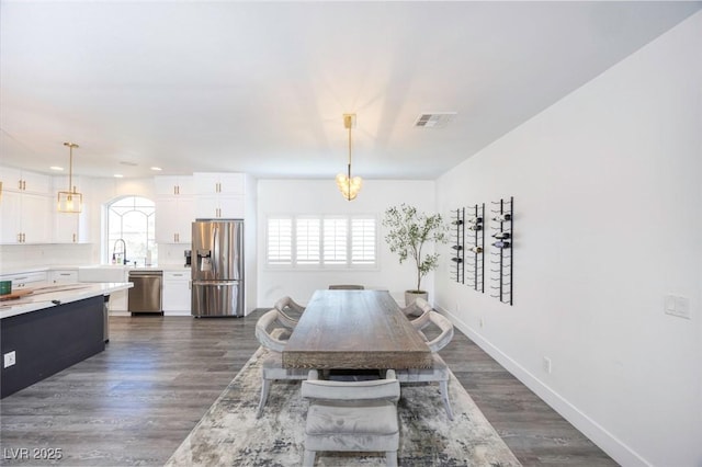 dining room featuring dark hardwood / wood-style flooring and sink