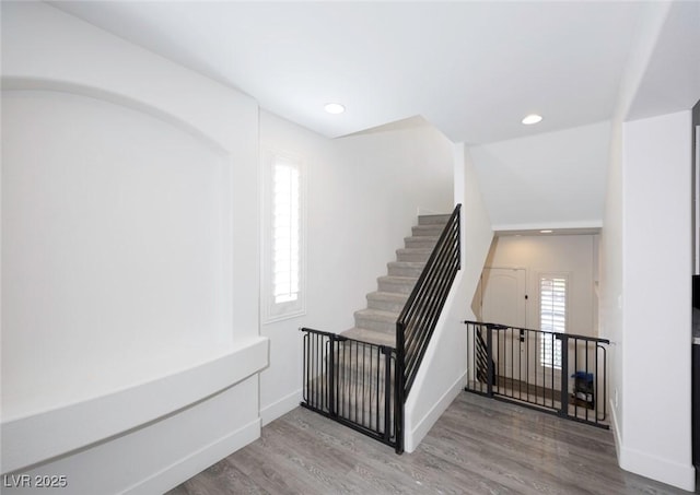 stairway featuring hardwood / wood-style flooring and plenty of natural light