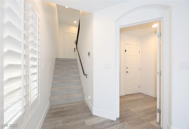 stairs with hardwood / wood-style floors