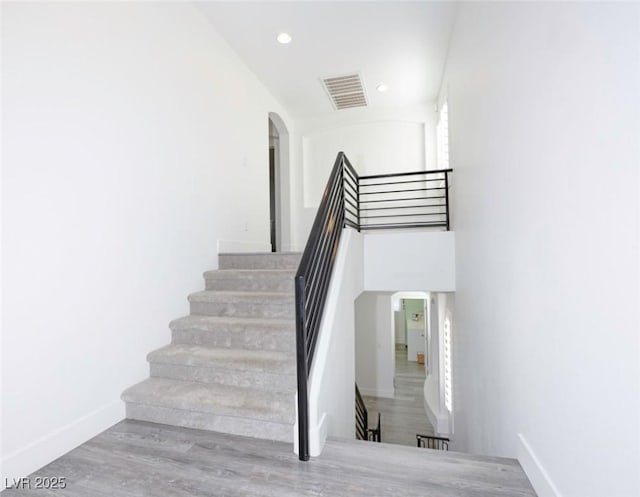 stairs with wood-type flooring