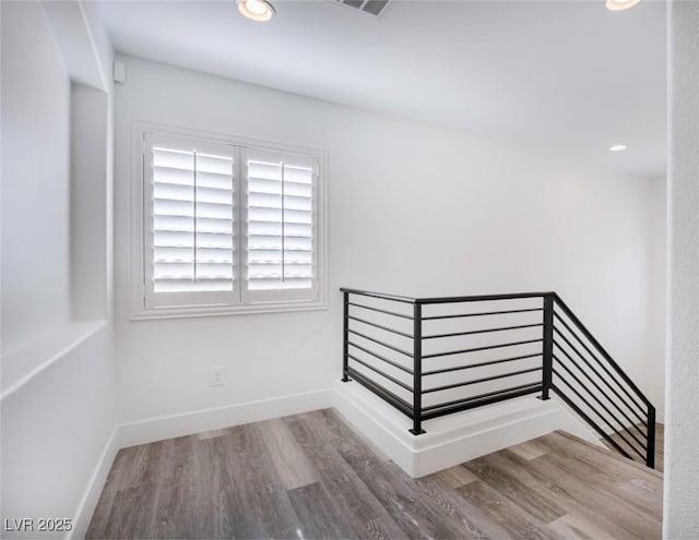 staircase with wood-type flooring