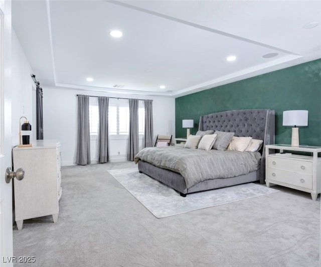 carpeted bedroom with a barn door