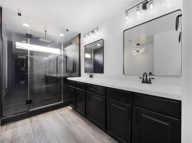 bathroom with hardwood / wood-style flooring, vanity, and an enclosed shower