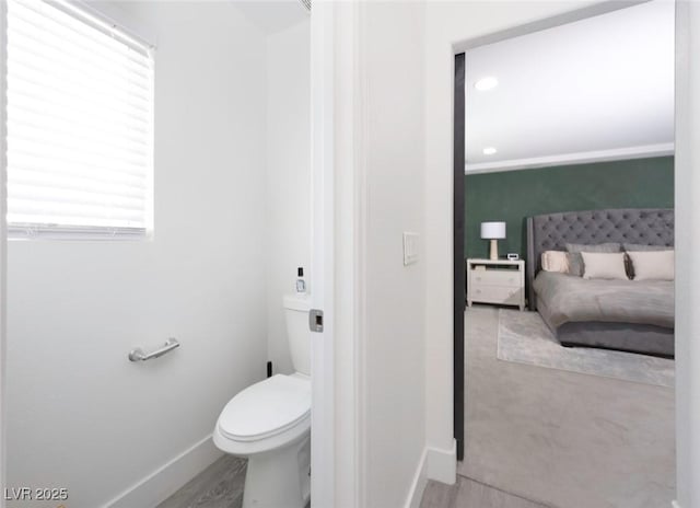 bathroom with hardwood / wood-style floors and toilet