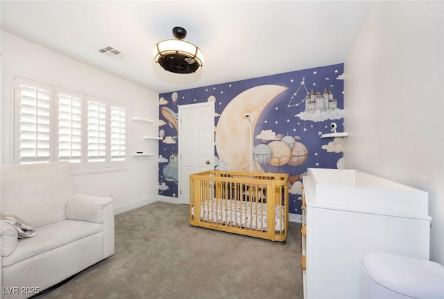 carpeted bedroom featuring a nursery area