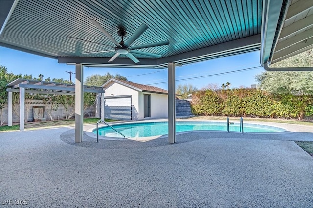 view of swimming pool featuring an outbuilding and ceiling fan