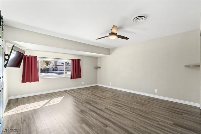 empty room featuring dark hardwood / wood-style floors and ceiling fan