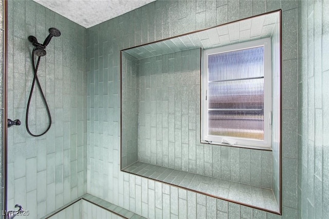 bathroom featuring a tile shower