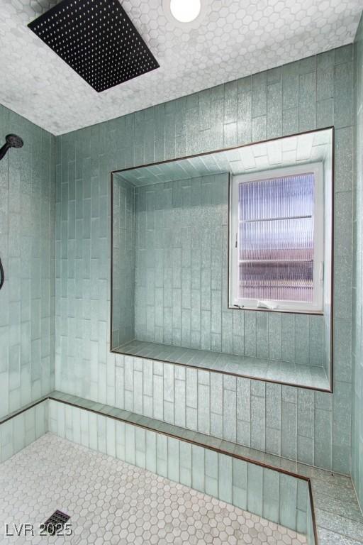 bathroom with a tile shower