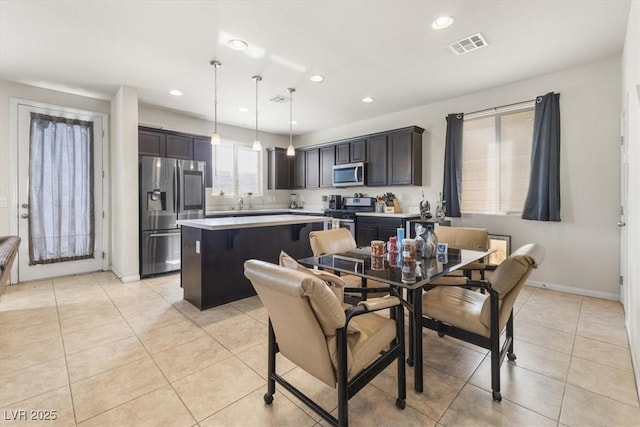 dining area featuring light tile patterned flooring and sink