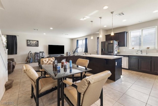 tiled dining area featuring sink