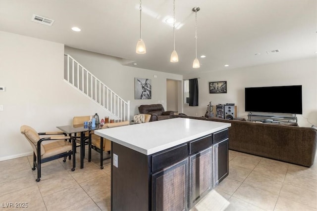 kitchen with hanging light fixtures, light tile patterned floors, and a kitchen island