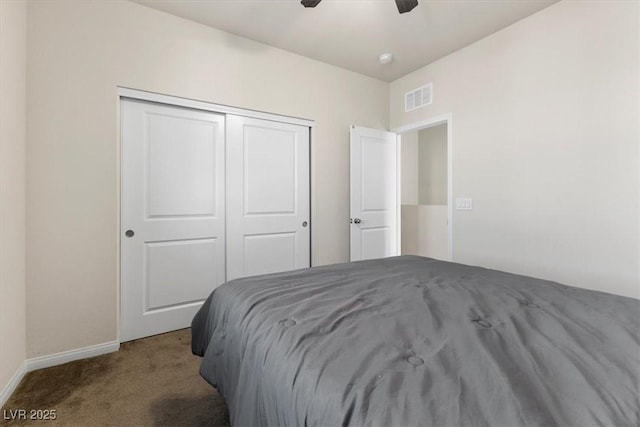 carpeted bedroom featuring ceiling fan and a closet