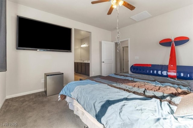 carpeted bedroom featuring ensuite bath and stainless steel fridge