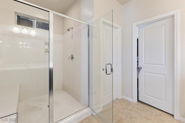 bathroom with tile patterned floors and walk in shower