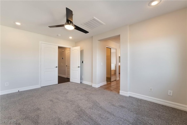 unfurnished bedroom featuring light carpet and ceiling fan