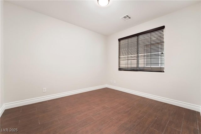 spare room featuring dark wood-type flooring