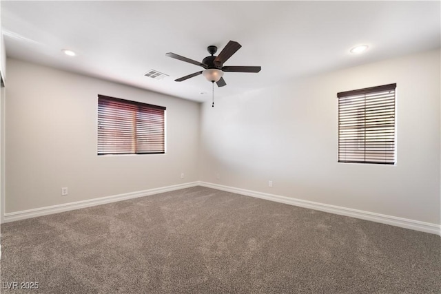 carpeted spare room with ceiling fan and a healthy amount of sunlight