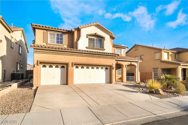 mediterranean / spanish-style house with cooling unit and a garage