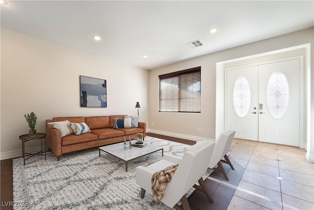 tiled living room featuring french doors