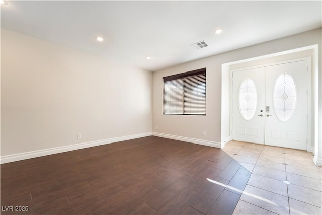 foyer with french doors and hardwood / wood-style floors