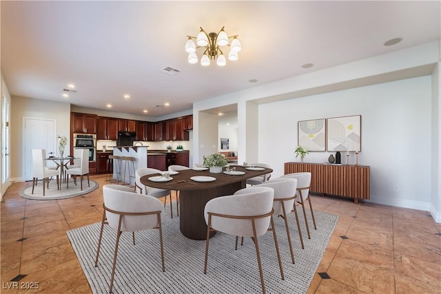 dining space featuring light tile patterned floors and a notable chandelier