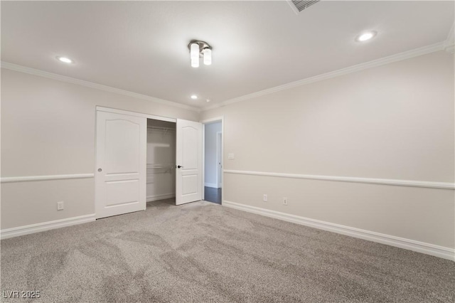 unfurnished bedroom with ornamental molding, carpet flooring, and a closet