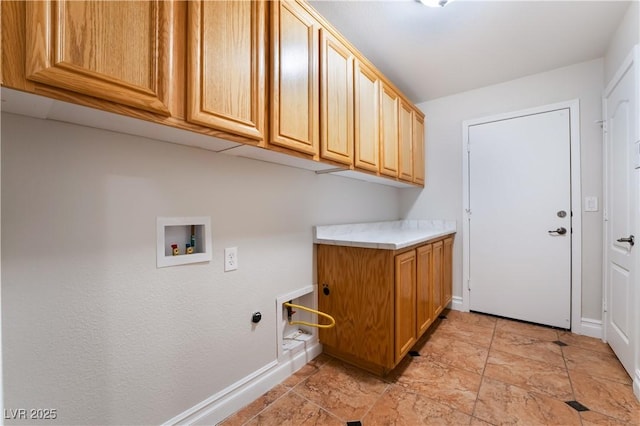 laundry room with washer hookup and cabinets