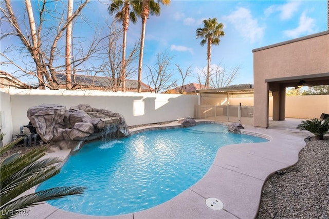 view of pool featuring pool water feature and a patio