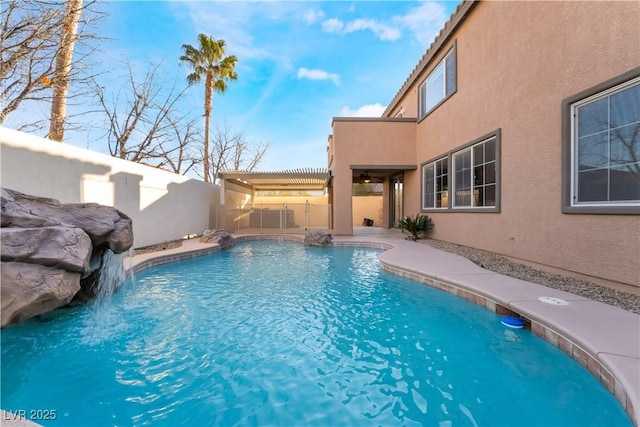 view of swimming pool featuring pool water feature and a pergola