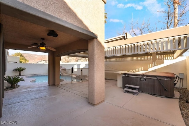 view of patio / terrace featuring a swimming pool with hot tub and ceiling fan