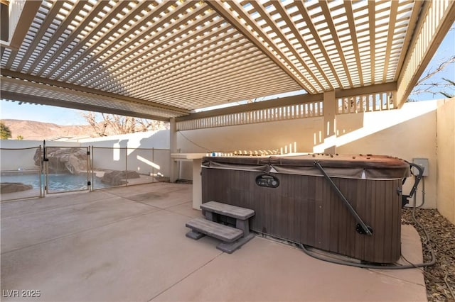 view of patio with a hot tub, a mountain view, and a pergola