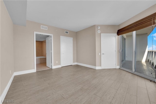 unfurnished room with light hardwood / wood-style floors