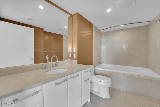 full bathroom with tiled shower / bath, vanity, toilet, and tile patterned flooring