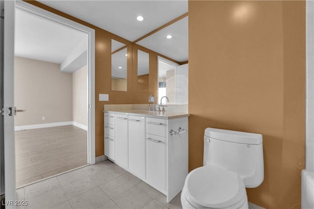 bathroom with tile patterned floors, vanity, and toilet