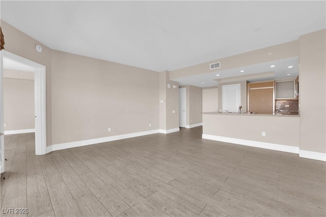 unfurnished living room featuring hardwood / wood-style floors