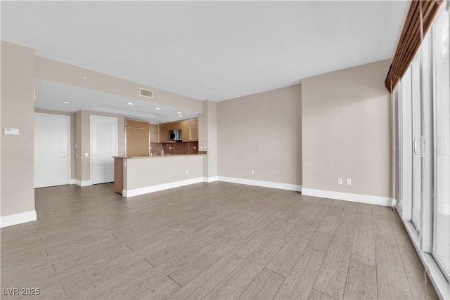 unfurnished living room with light hardwood / wood-style flooring