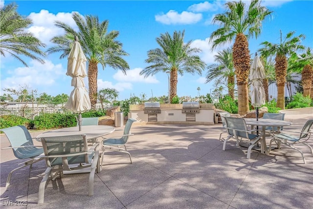 view of patio with area for grilling and a grill