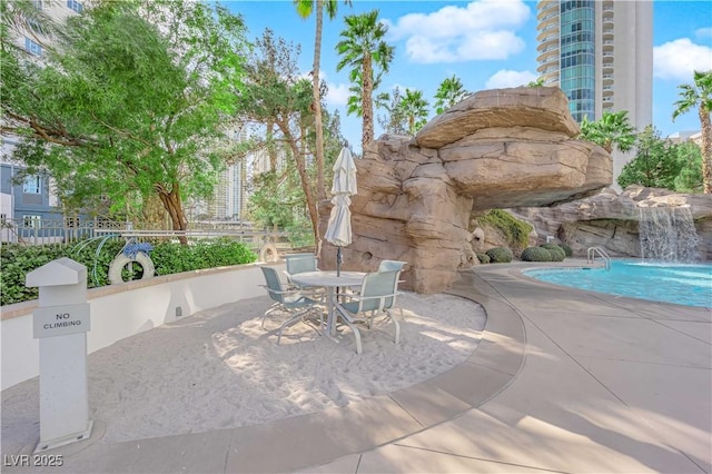 view of patio / terrace with pool water feature and a community pool