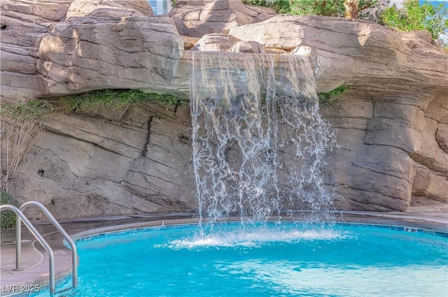 view of swimming pool featuring pool water feature