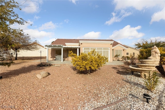 rear view of property featuring a patio area