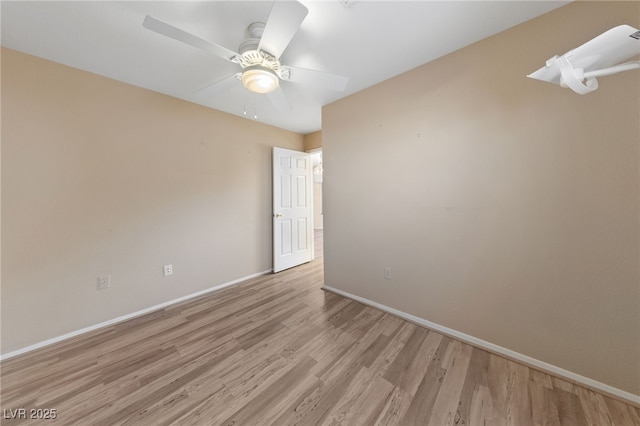 empty room with ceiling fan and light hardwood / wood-style floors