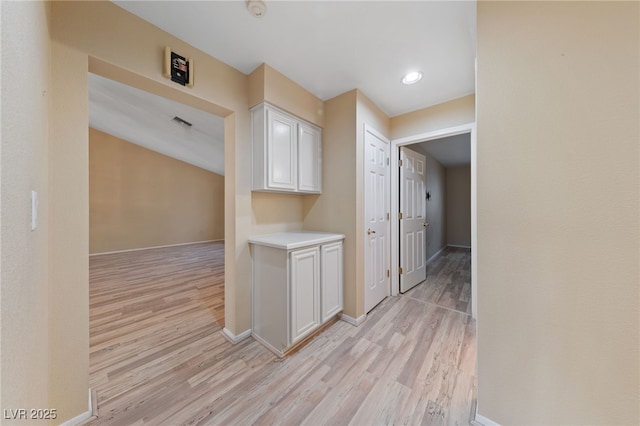 hall with light hardwood / wood-style floors