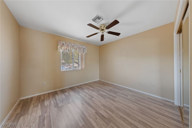 spare room featuring ceiling fan and light hardwood / wood-style flooring