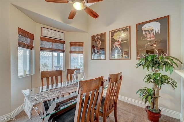 dining space with ceiling fan and carpet